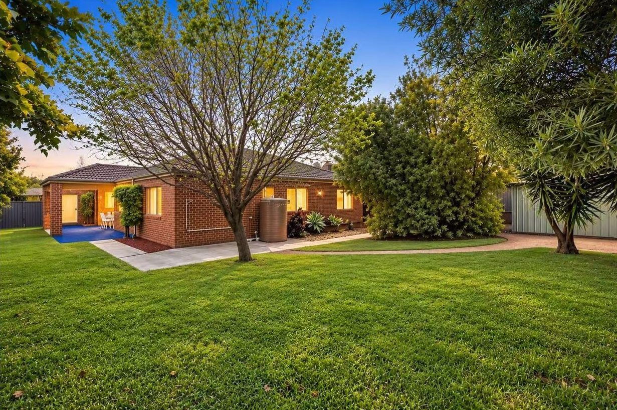 Rear view of 9 Gilmore Grove Point Cook showing the huge established backyard at dusk